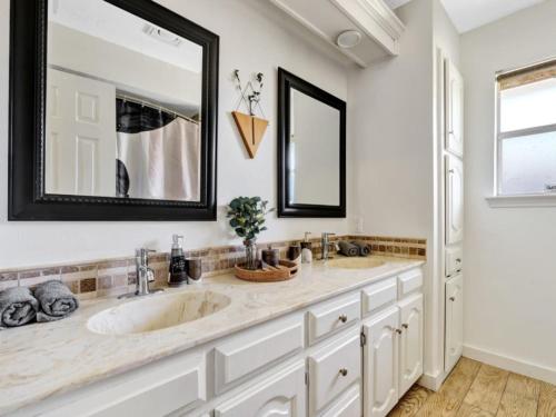 a bathroom with a large sink and a mirror at City Gem 4BR with POOL Sleeps 8 in Plano