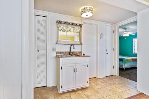 a kitchen with a sink and a mirror at Sea Cabin 147 - 2nd Row - Cherry Grove Section in Myrtle Beach