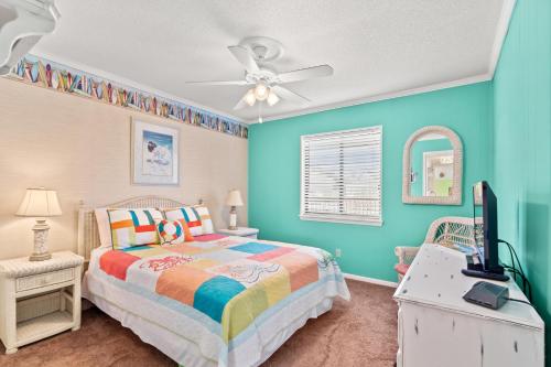a bedroom with a bed and a ceiling fan at Sea Cabin 147 - 2nd Row - Cherry Grove Section in Myrtle Beach
