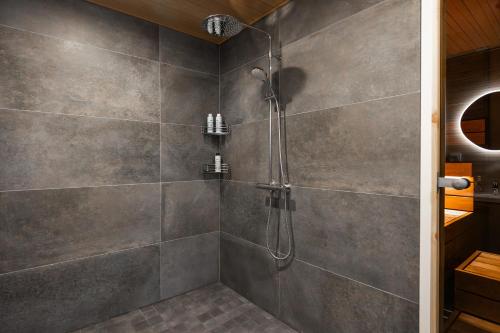 a bathroom with a shower with a glass door at Villa Relax in Rovaniemi