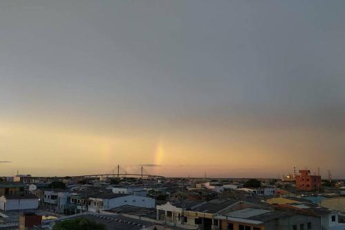 a rainbow in the sky over a city at Apto 202, área mtana de Barranquilla in Soledad