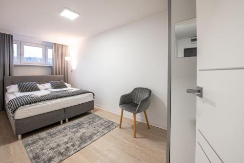 Posteľ alebo postele v izbe v ubytovaní Apartament26