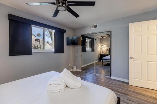 a bedroom with a bed and a ceiling fan at 573 Queen's Grant in Coffeyville