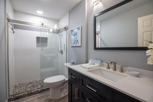 a bathroom with a sink and a toilet and a mirror at 573 Queen's Grant in Coffeyville