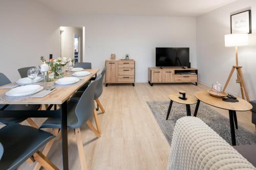 Televízia a/alebo spoločenská miestnosť v ubytovaní Apartament26