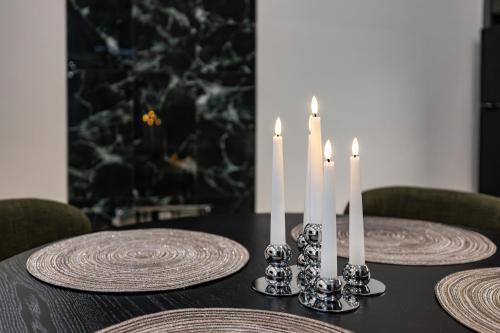 a table with two plates and candles on it at Villa Relax in Rovaniemi
