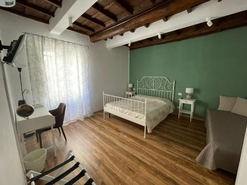a bedroom with a bed and a desk and a couch at Il Giardino di Ambra Casa Vacanze indipendente in Viterbo