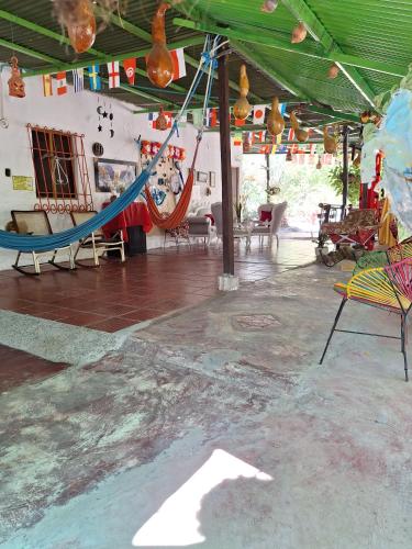 a room with a hammock and chairs in it at Alojamiento Casa de campo los Cactus in Villavieja