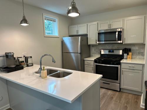 a kitchen with a sink and a stainless steel refrigerator at Aldrich Oasis in Minneapolis