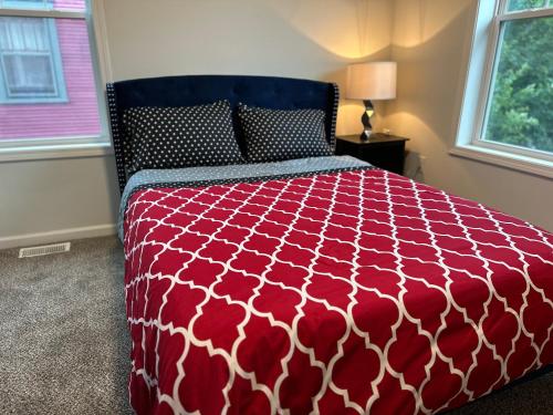a red and white bed in a bedroom with a window at Aldrich Oasis in Minneapolis