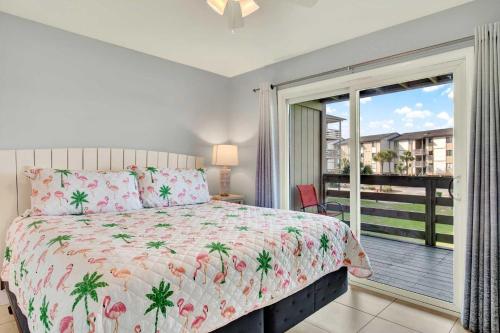 a bedroom with a bed and a balcony at Lighthouse Point Rental 35A in Tybee Island