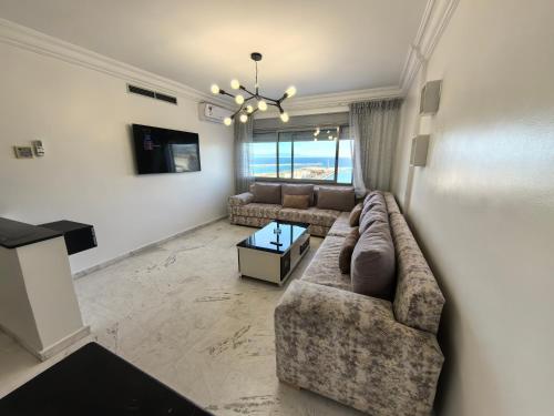 a living room with a couch and a table at City Bleu Maroc in Tangier