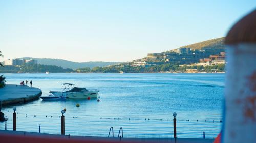 a boat is docked in a large body of water at Club Aquarium Hotel & Spa in Guvercinlik