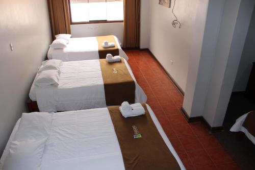 Ein Bett oder Betten in einem Zimmer der Unterkunft QASANA HOTEL Plaza Calca