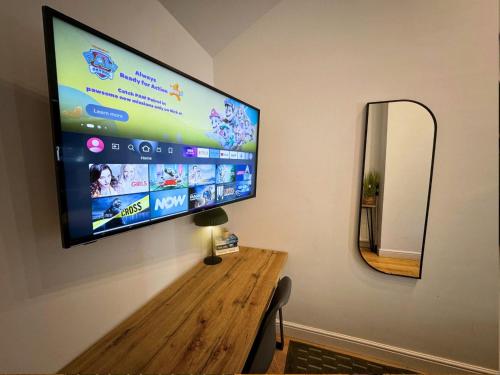a large flat screen tv hanging on a wall at Freeman Hot Tub House, Free Parking, Transport Links in Longbenton