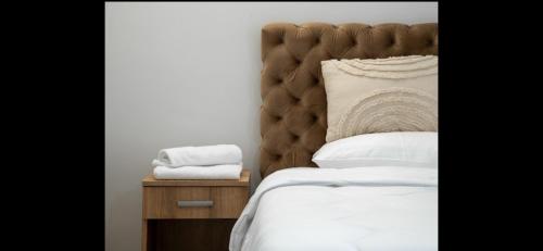 a bedroom with a large bed and a wooden nightstand at Vila Tom & Jerry in Raška