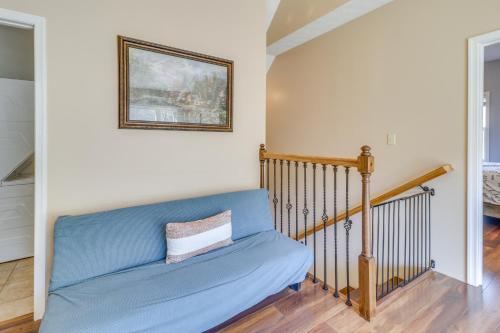 a blue couch in a living room with a picture on the wall at Pet-Friendly Shenandoah Cabin with Fire Pit and Grill! in Shenandoah
