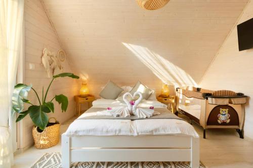a bedroom with a bed with a bow on it at Kopań Kabana in Darłowo