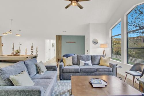 a living room with two couches and a table at Yosemite Forest Villa in Oakhurst