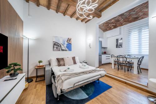 a bedroom with a bed and a dining room at Martin's Home - Spacious 60 sqm apartment in Modena historic center ideal for families and business stays in Modena