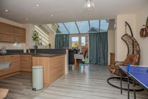 a kitchen and living room with a large window at Cosy townhouse, new build, 5 bedrooms, Sleeps 8, Free Parking in Northfleet