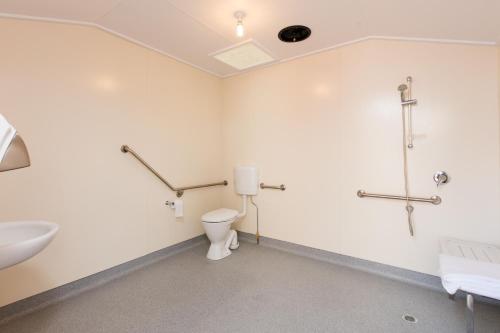 a bathroom with a toilet and a sink at Mungo Shearers' Quarters in Mungo