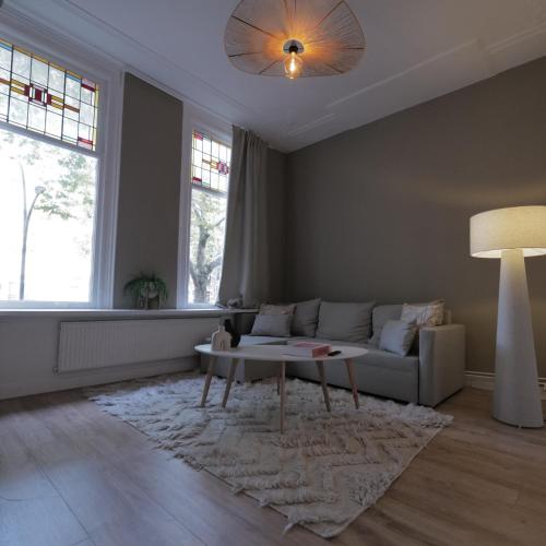 a living room with a couch and a table at Living Room Apartments in Rotterdam