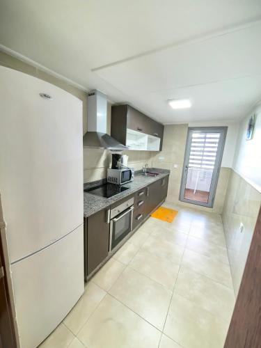 a kitchen with stainless steel appliances and a tile floor at City Bleu Maroc in Tangier