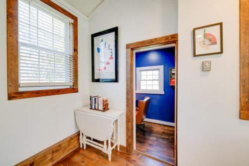 a hallway with a white desk and a blue wall at Less Than 4 Mi to Cooperstown Charming Historic Home! in Fly Creek