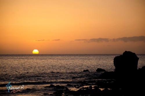 a sunset over the ocean with the sun in the distance at Furgot3 in Agulo