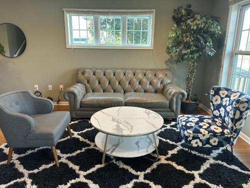a living room with a couch and two chairs and a table at Dupont4 Oasis in Minneapolis