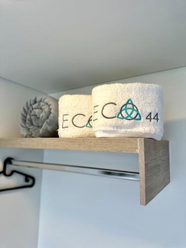 two towels on a shelf in a room at Hotel ECO 44 in Medellín