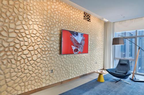 a room with a wall with a painting on it at Aloft Chicago Mag Mile in Chicago