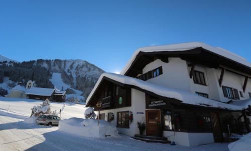 a building with snow on the roof of it at Gatterhof in Riezlern