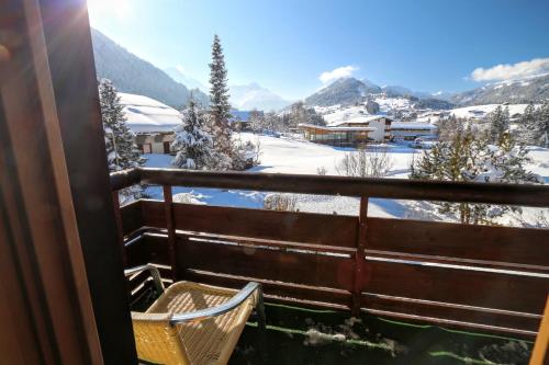 a balcony with a view of a snow covered mountain at Gatterhof in Riezlern