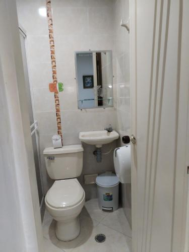 a small bathroom with a toilet and a sink at Hotel La Leyenda Vallenata in Valledupar