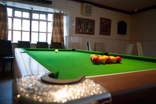 a pool table with a ball on top of it at Dalgair House Hotel in Callander