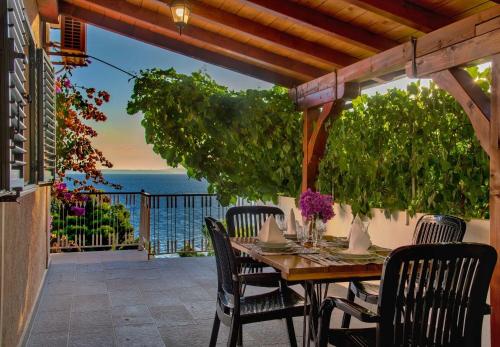 a table on a patio with a view of the ocean at Apartments Milica in Krilo