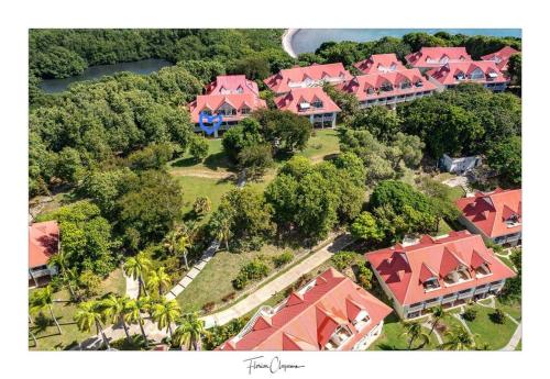 an aerial view of a house with red roofs at TI KAZ DOUDOU - village de vacances bord de mer in Sainte-Anne
