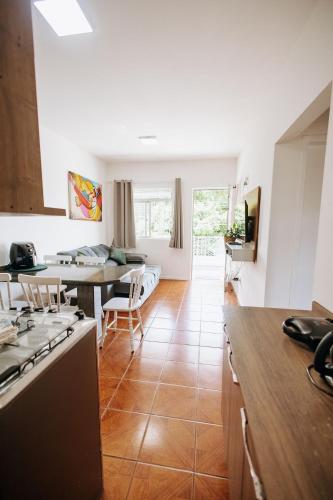 a kitchen with a table and a dining room at Residencial Mizinho Ap2 in Florianópolis