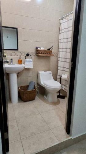 a bathroom with a toilet and a sink at Casa Jumay Mallorca in Achiotes Jumay