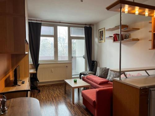 a living room with a red couch and a window at Praha 5 Barrandov- Apartmán Daniela in Prague