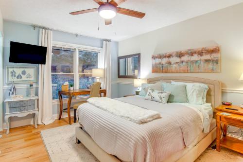 a bedroom with a bed with a ceiling fan and a desk at Blue Ridge Mtn Retreat Porches and Creek Access in Hendersonville