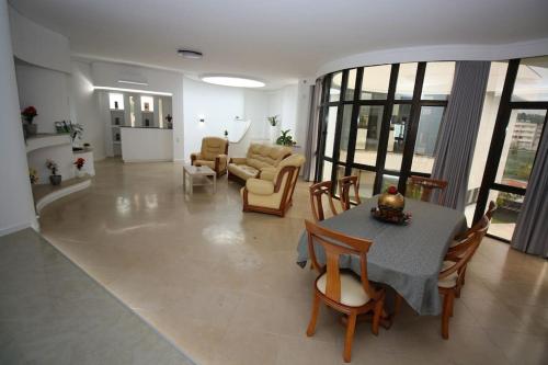 a living room with a table and chairs at Requinte House in Nogueira de Cravo