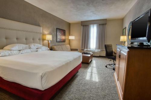 a hotel room with a bed and a flat screen tv at Drury Inn & Suites San Antonio Near La Cantera in San Antonio
