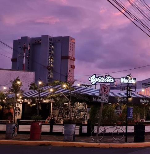 a restaurant with a bike parked in front of it at Escalante Executive Studio AC in San José
