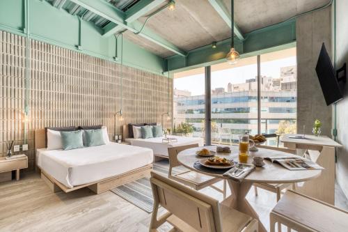 a living room with a bed and a table and a couch at Collections by ULIV Polanco in Mexico City