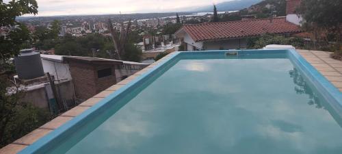 a large blue swimming pool on top of a house at Chalet de Montaña a 8 cuadras del centro de Carlos Paz con pileta de 9 x 4 in Villa Carlos Paz
