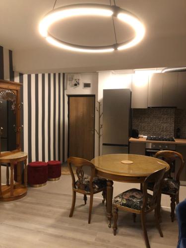a kitchen with a table and chairs and a refrigerator at La Vista Ultracentral - Private Parking in Craiova