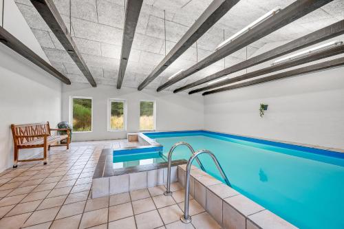 a swimming pool in a building with a pool at Large Pool House With Activity Room Located In Peaceful Surroundings in Frøstrup